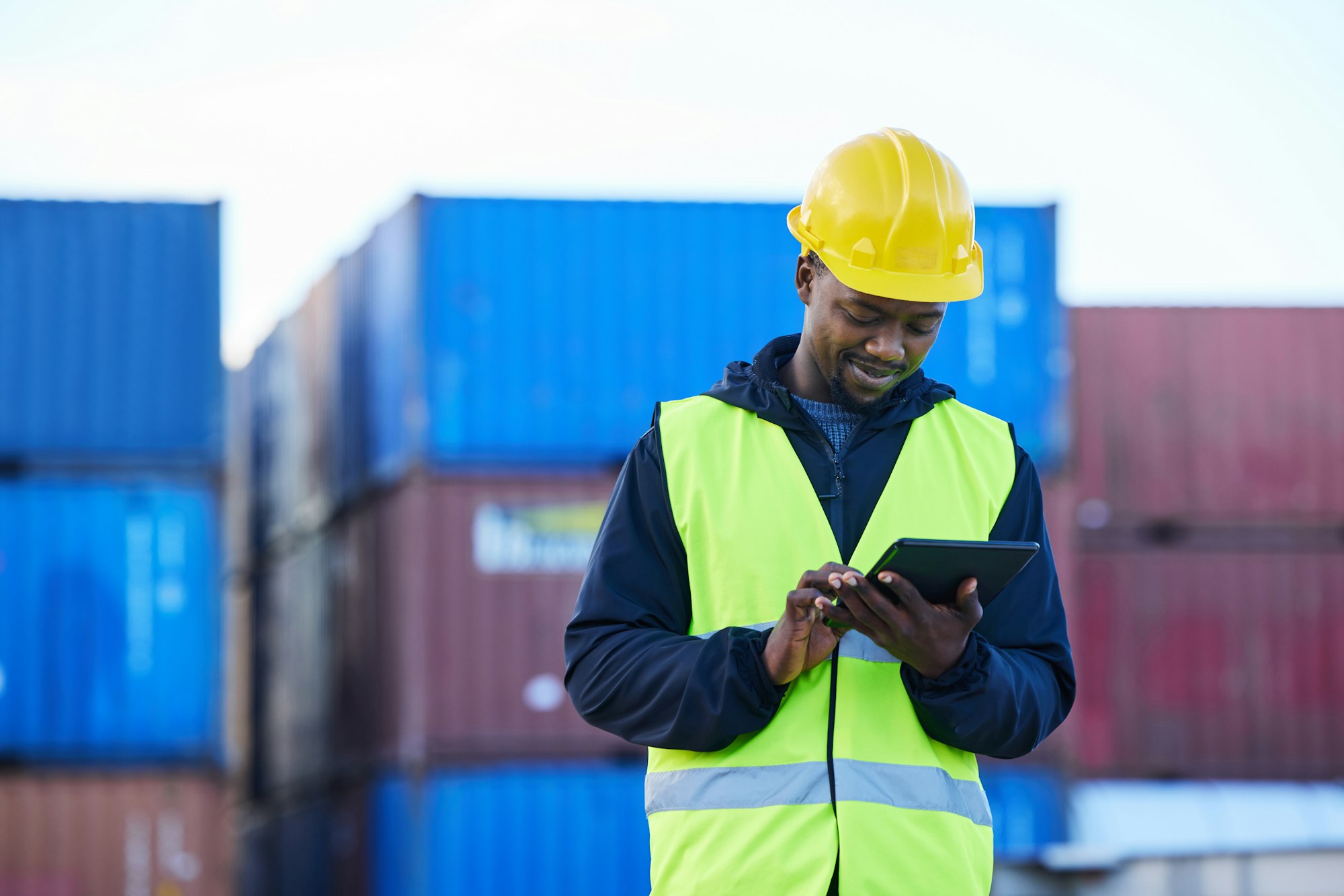 Logistics, digital tablet and black man in supply chain management at shipping, cargo or freight wa